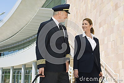 Pilot And Flight Attendant Outside Building