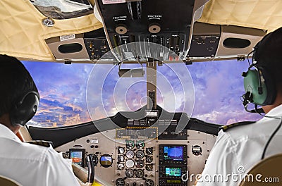 Pilots in the plane cockpit and sunset