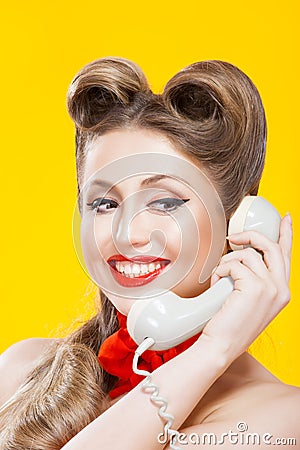 Pin-up girl talking on retro telephone