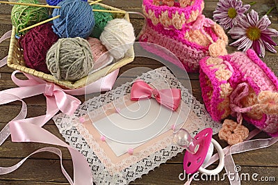 Pink greeting card with baby knitting things