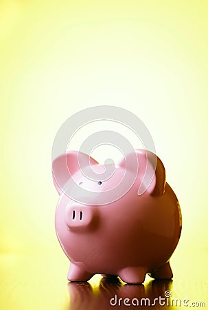 Pink piggy bank on a bright yellow background