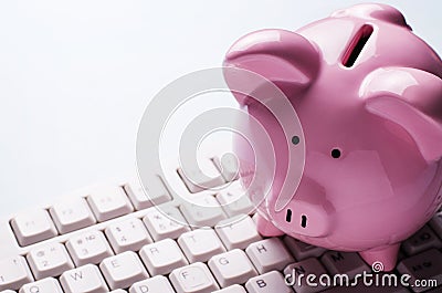 Pink piggy bank on a computer keyboard