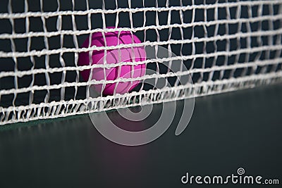 Pink table tennis ball in the net