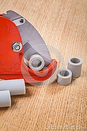 Pipe cutter with pipes on woodn board