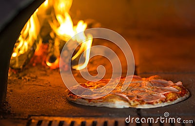 Pizza baking in traditional stone oven