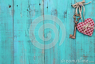 Plaid heart and bronze skeleton key hanging on antique teal blue wood door