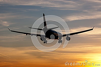 Plane landing in sunrise