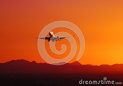 Plane taking off at sunset, Arizona