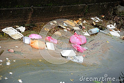 Plastic and polystyrene fast food packaging in a river