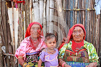 Playa Chico village, Panama - August, 4, 2014: Three generations of kuna indian women in native attire sell handcraft clothes