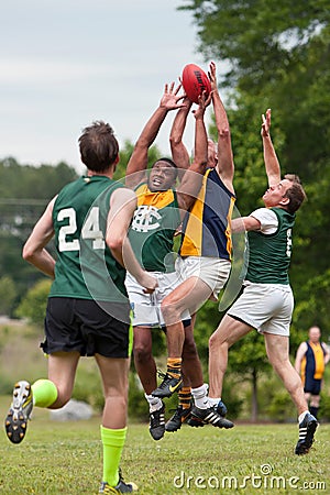 Players Battle For Ball In Australian Rules Football Game