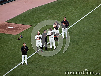 Players stand with hats removed, National anthem