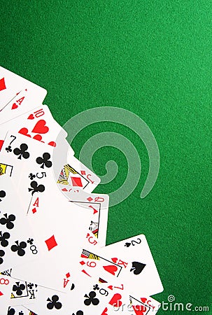 Playing cards on green casino background