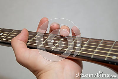 Playing guitar: flageolet finger touch on string