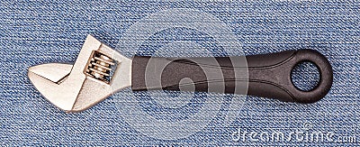 Pliers black handle tool isolated on blue jeans background