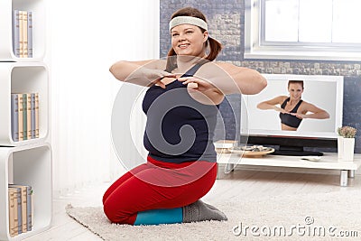 Plump female doing workout at home