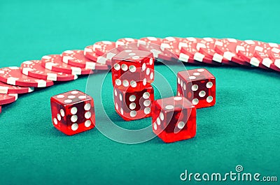 Poker gambling chips on a green playing table