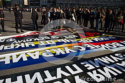 Police chief Viktor Biryukov checks posters opposition peace March