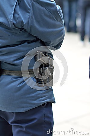 Police officer with gun in holster