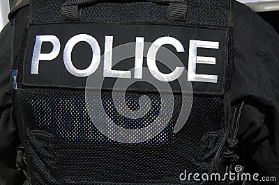 POLICE officer logo on SWAT officers vest.