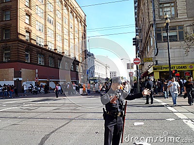 Police officers holds out hands to wave on crowd