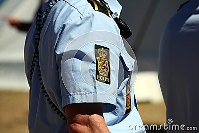 Police sign on police officers arm