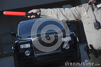 Policeman Holding Hand Baton To Stop Car