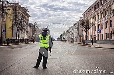 Policeman looks at the empty street