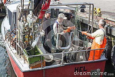 Polish fishermen working with net