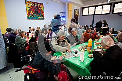 Poor people have lunch at the Christmas charity dinner for the homeless