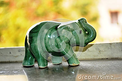 Porcelain elephant toy at window
