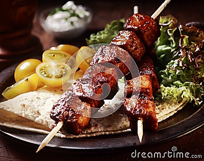 Pork kebabs with tortilla and salad