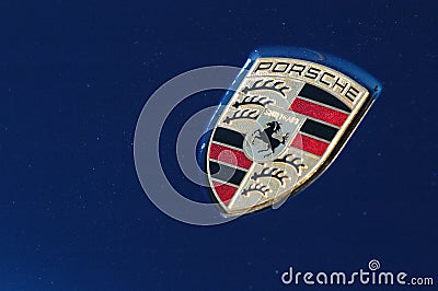 Porsche logo on blue sport car