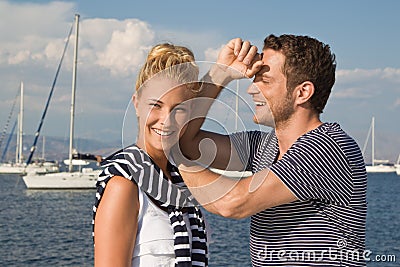 Portrait of attractive young couple in love on sailing boat.