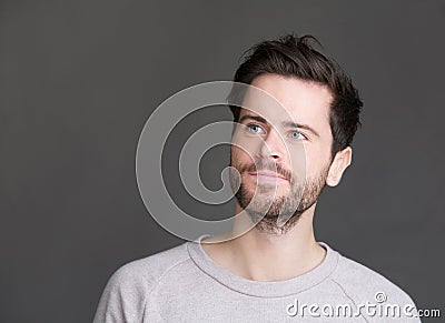 Portrait of an attractive young man with beard looking away