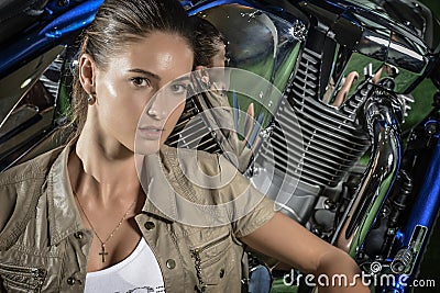 Portrait of attractive young woman, over motorcycle background