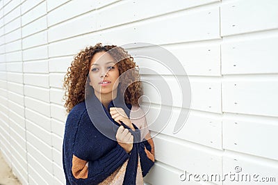 Portrait of an attractive young woman posing outdoors with sweater
