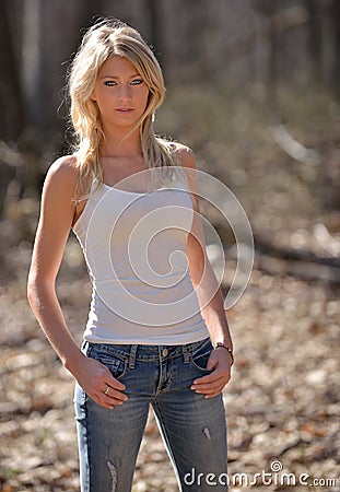 http://thumbs.dreamstime.com/x/portrait-baeutiful-smiling-blonde-woman-stunning-young-model-white-tank-top-blue-jeans-standing-woods-afternoon-30950121.jpg