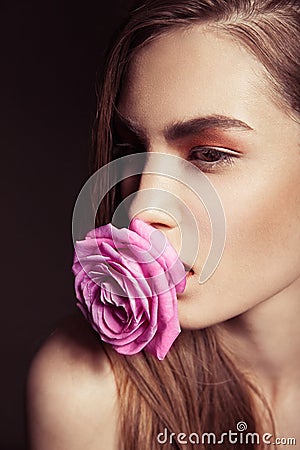 Portrait of beautiful brunette woman with rose