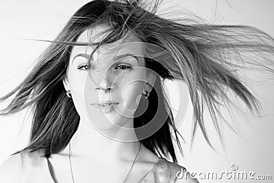 Portrait of beautiful girl with long hair blowing in breeze