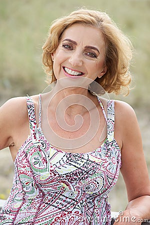 Portrait of a beautiful older woman smiling outdoors