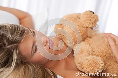 Portrait of beautiful woman holding teddy bear
