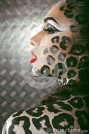 Portrait of beautiful young european model in cat make-up and bodyart