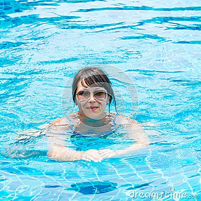 Portrait of a beautiful young girl in sunglasses floating in the