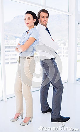 Portrait of a business couple standing with arms crossed
