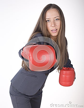 Portrait of business woman boxing in red gloves. business activity