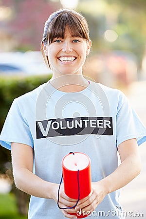 Portrait Of Charity Volunteer On Street With Collection Tin