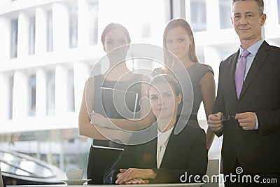 Portrait of confident business people in office cafeteria