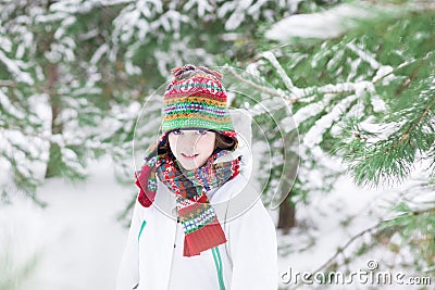 Portrait of a cute child playing in a snowy forest