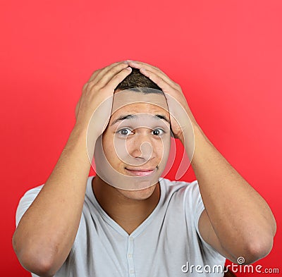 Portrait of desperate man against red background